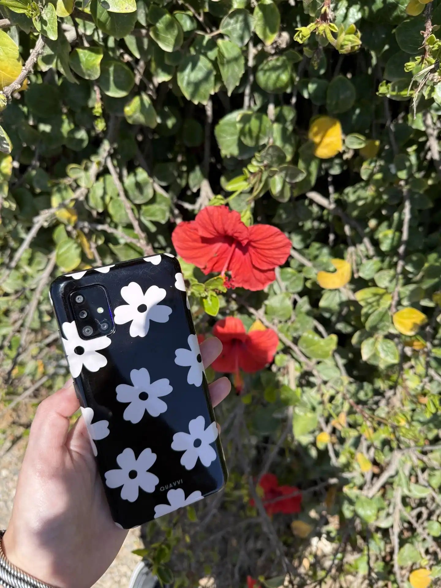 Black phone case with white flowers.