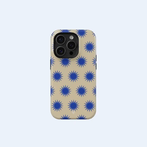 An iPhone 15 Pro Max with a cream-colored case adorned with a repeating pattern of blue sunbursts.